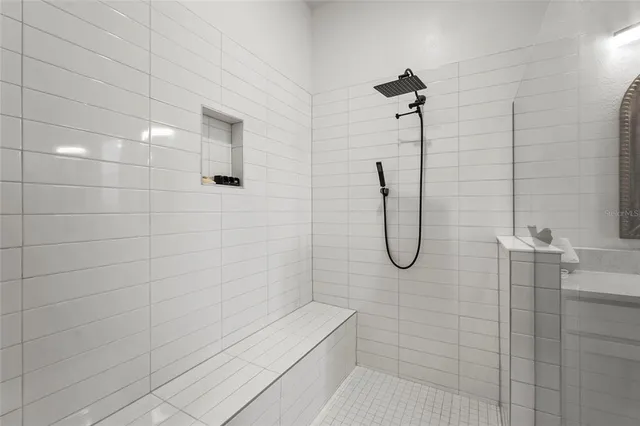 a front view of a house with a yard and potted plants