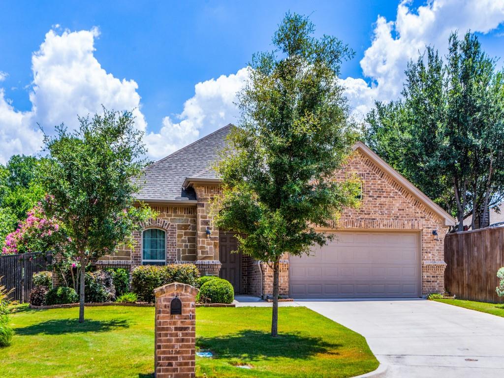 521 Corriente Trail Azle, TX 76020 - Photo 1 of 25 a front view of a house with garden and trees