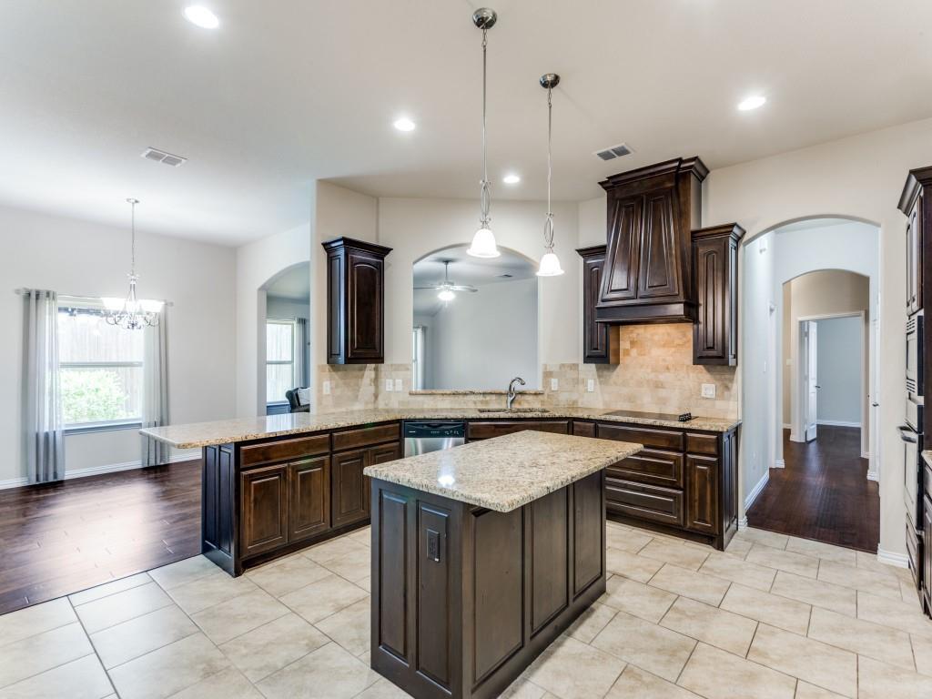 521 Corriente Trail Azle, TX 76020 - Photo 11 of 25 a large kitchen with stainless steel appliances granite countertop a stove and a sink
