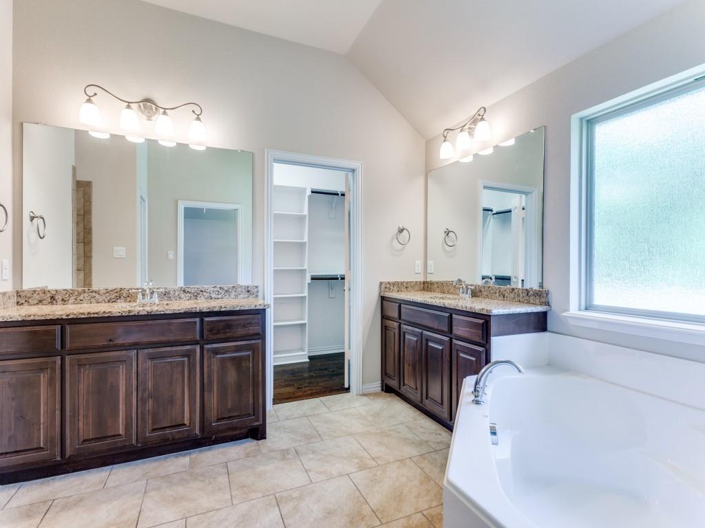 521 Corriente Trail Azle, TX 76020 - Photo 15 of 25 a bathroom with a granite countertop double vanity sink and a mirror
