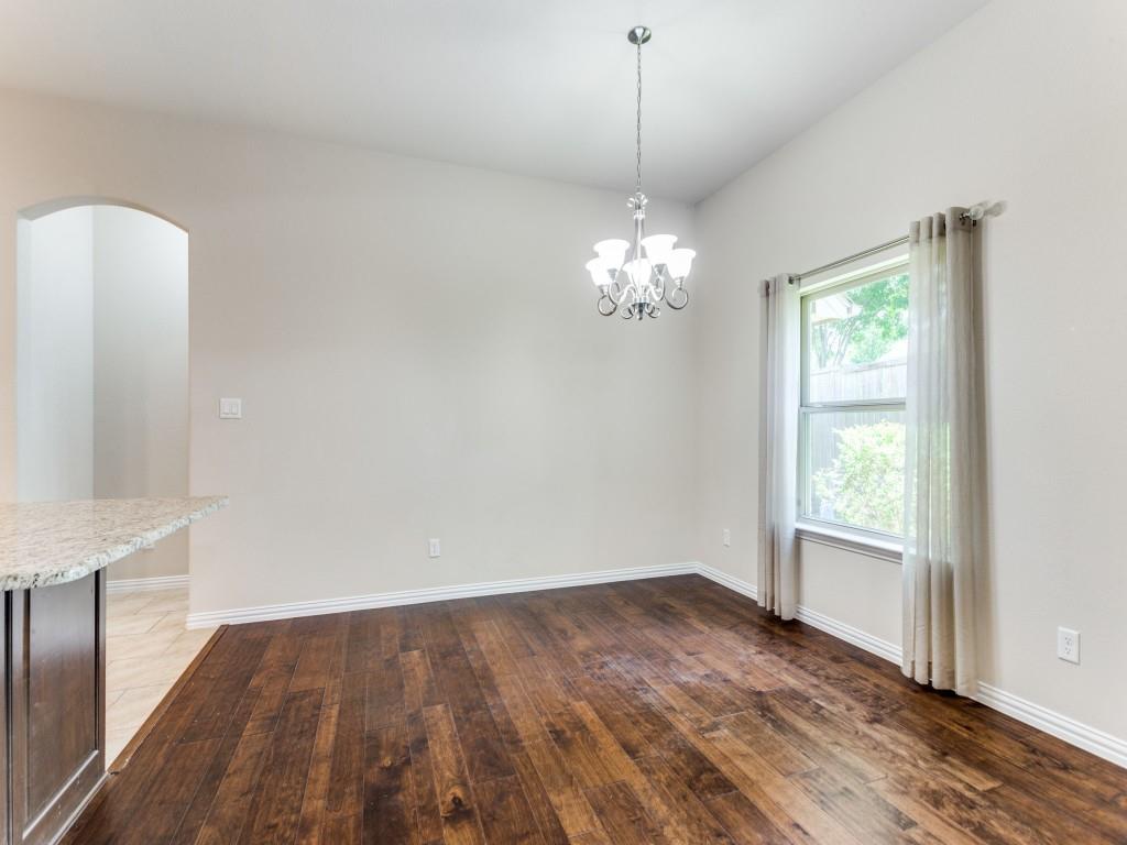 521 Corriente Trail Azle, TX 76020 - Photo 7 of 25 a view of an empty room with wooden floor and a window