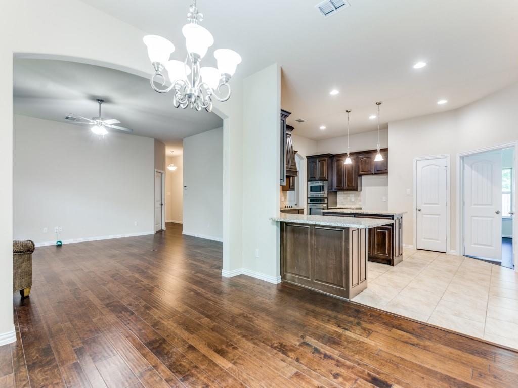 521 Corriente Trail Azle, TX 76020 - Photo 8 of 25 a view of kitchen with granite countertop cabinets stainless steel appliances and a counter top space