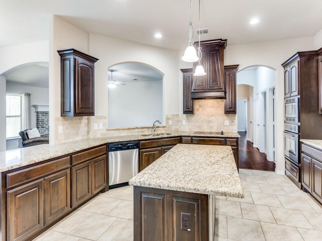 521 Corriente Trail Azle, TX 76020 - Photo 10 of 25 a kitchen with stainless steel appliances granite countertop a sink a counter space and wooden floor