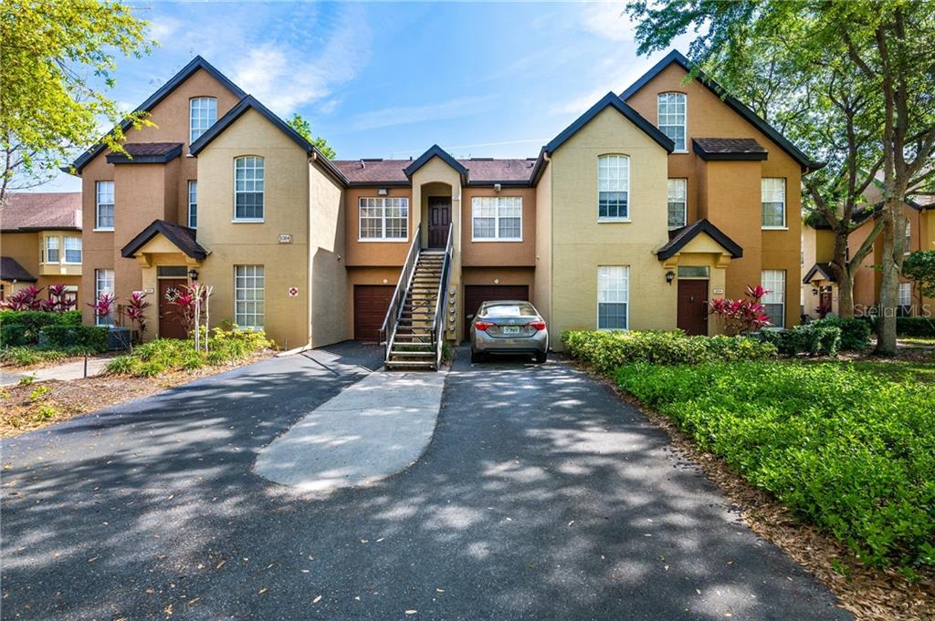 6364 Raleigh Street, Unit 1604 Orlando, FL 32835 - Photo 1 of 1 a front view of a house with a yard and garage