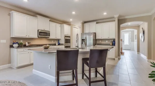 a kitchen with counter space appliances a sink and cabinets