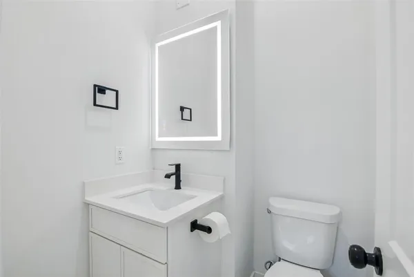 a bathroom with a sink a toilet and a mirror