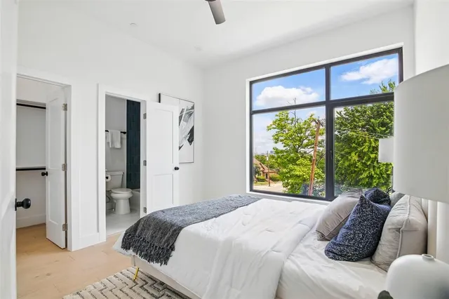 a bedroom with a large bed and a window