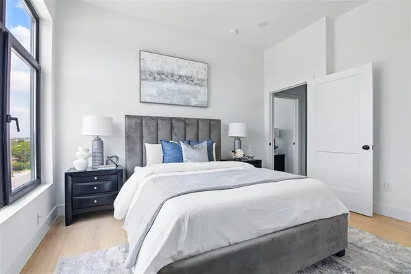 a bedroom with a bed and a window
