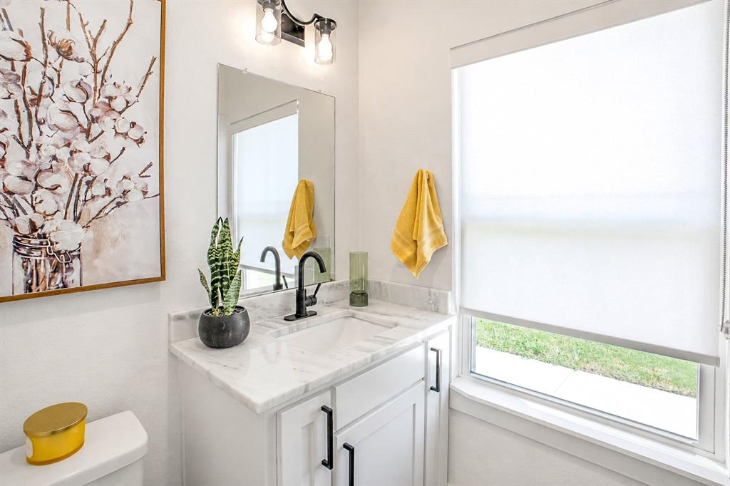 311 Dobbs Trail Springtown, TX 76082 - Photo 30 of 33 a bathroom with a sink and a mirror