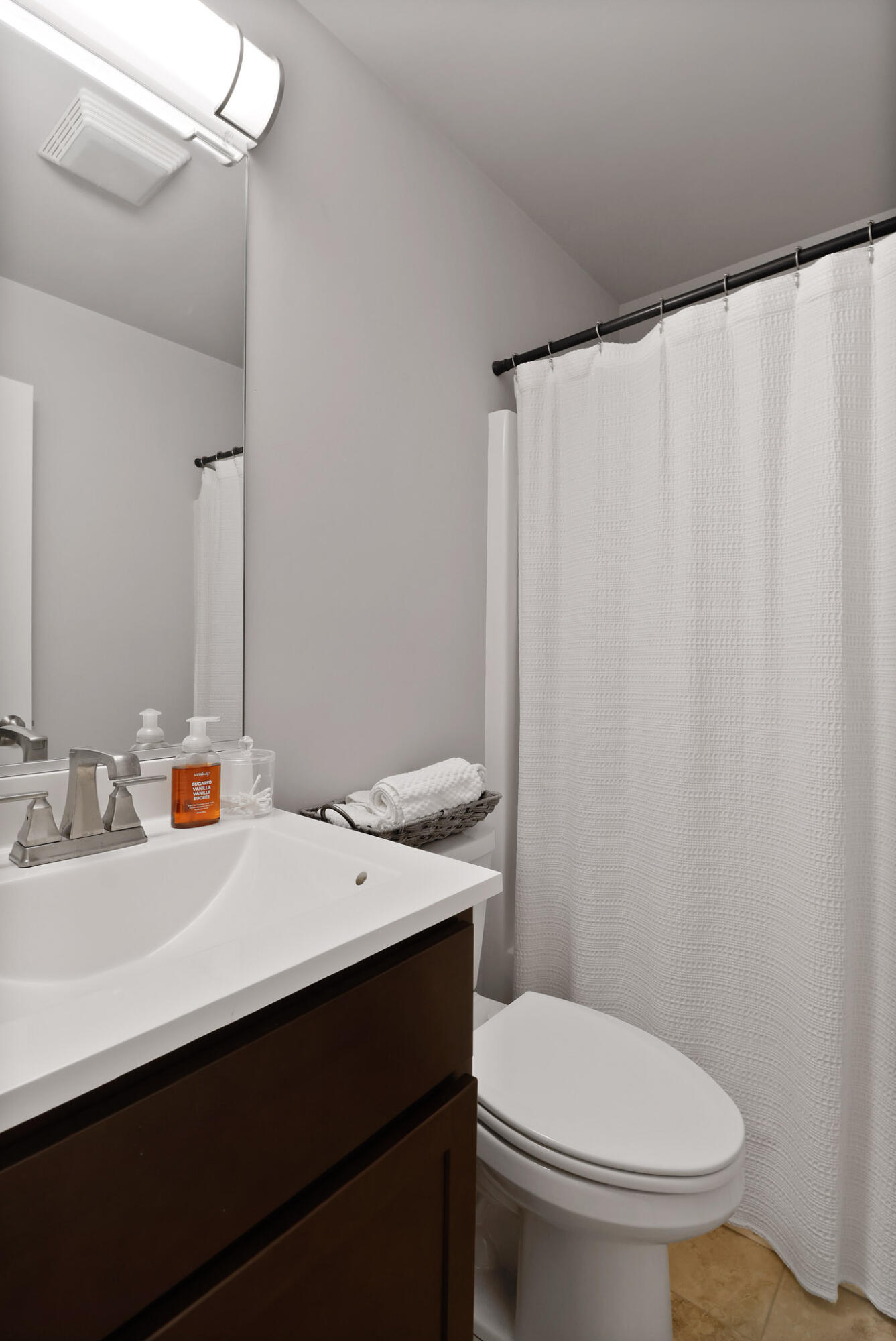 274 Westport Road Valparaiso, IN 46385 - Photo 20 of 28 a bathroom with a sink a toilet a mirror and shower curtain