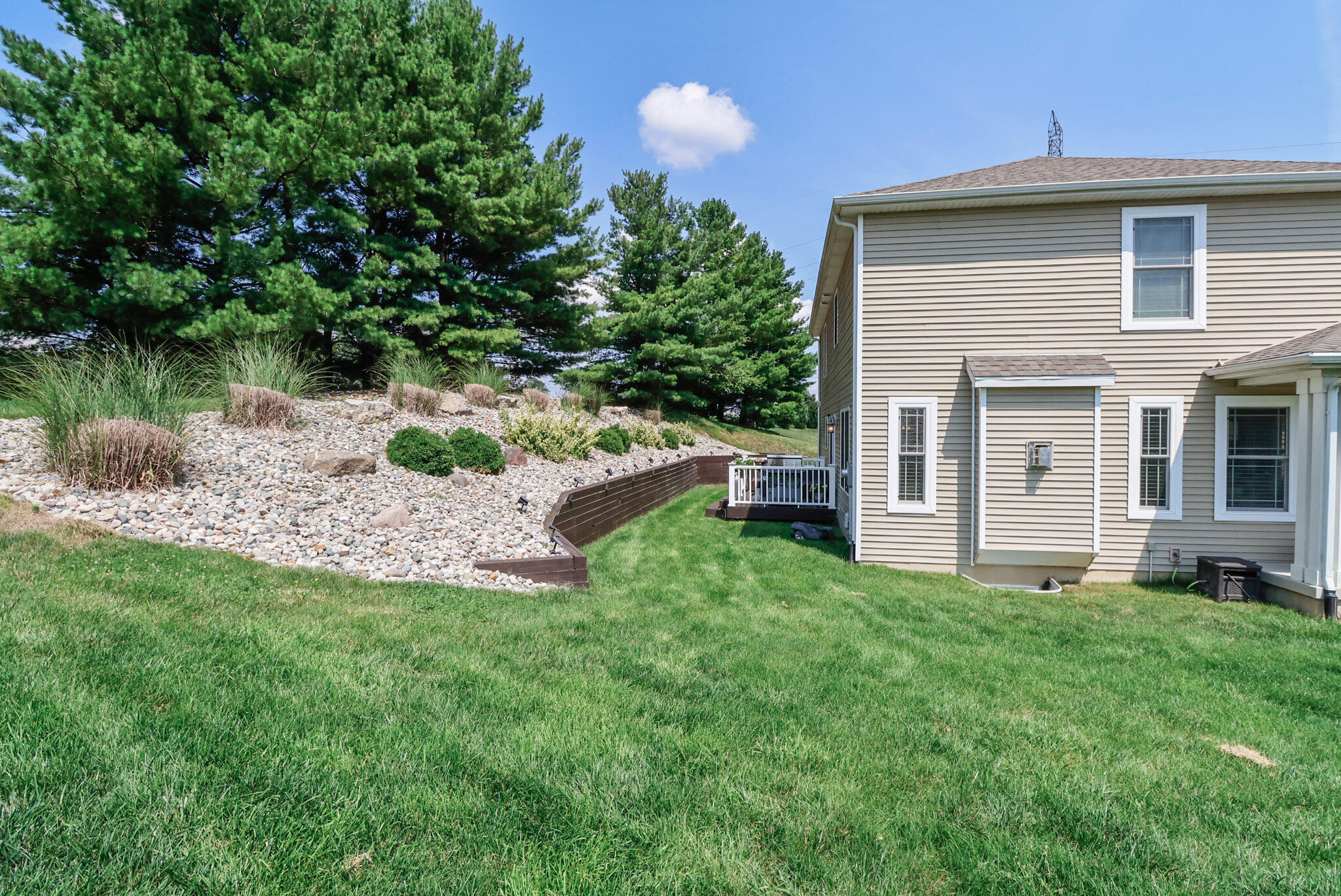 274 Westport Road Valparaiso, IN 46385 - Photo 28 of 28 a backyard of a house with table and chairs plants and large tree