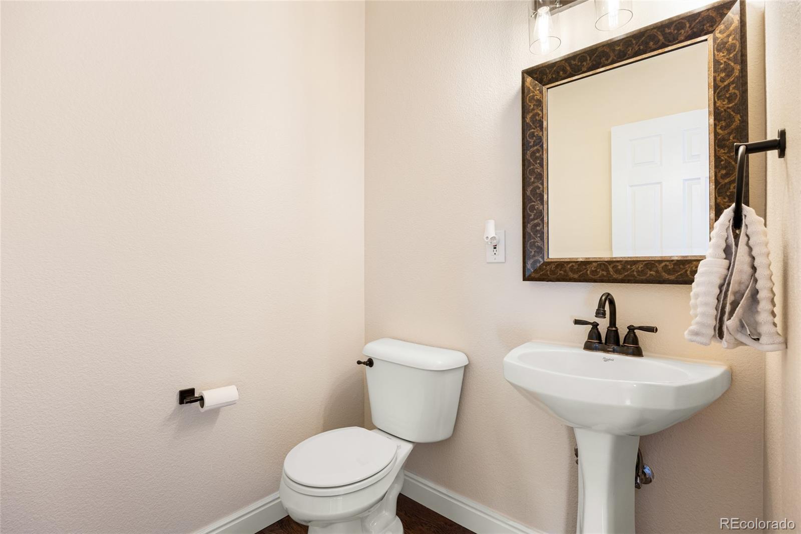 10655 Cherrybrook Circle Highlands Ranch, CO 80126 - Photo 14 of 42 a bathroom with a toilet sink and mirror