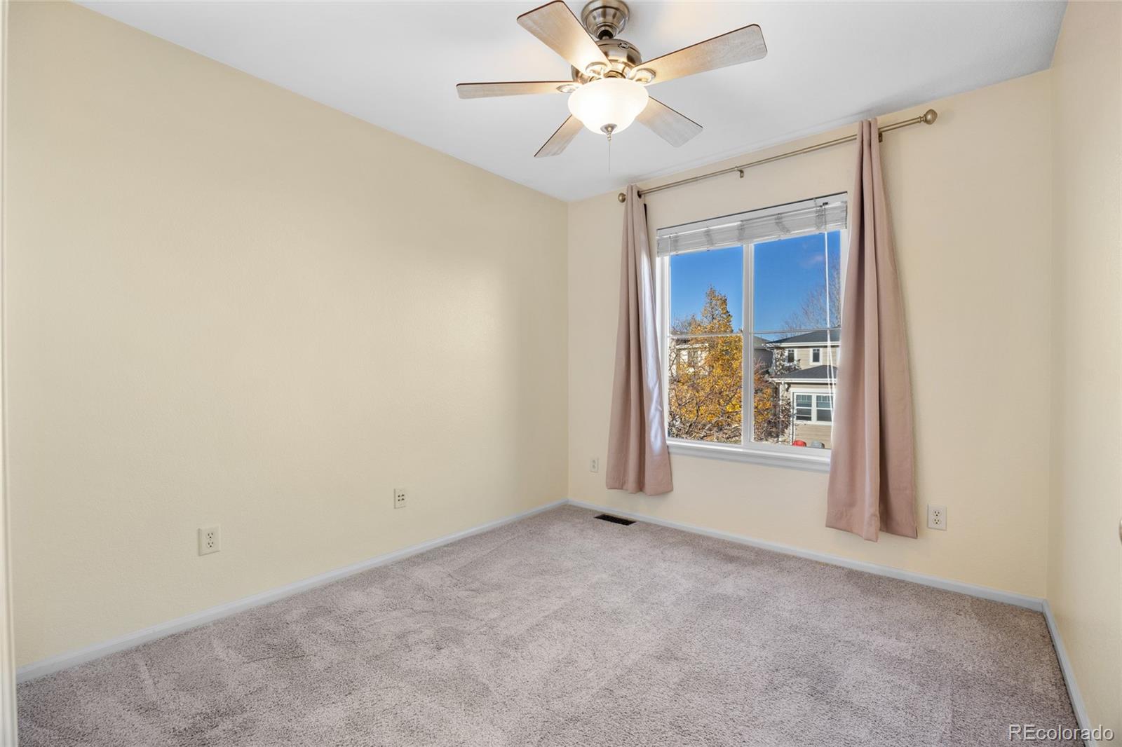 10655 Cherrybrook Circle Highlands Ranch, CO 80126 - Photo 20 of 42 an empty room with a window and a fan