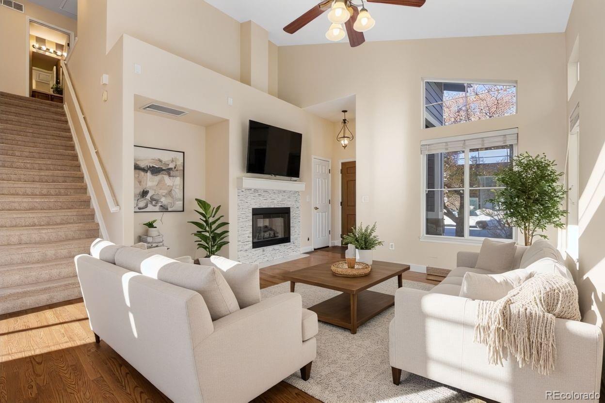 10655 Cherrybrook Circle Highlands Ranch, CO 80126 - Photo 6 of 42 a living room with furniture a fireplace and a flat screen tv