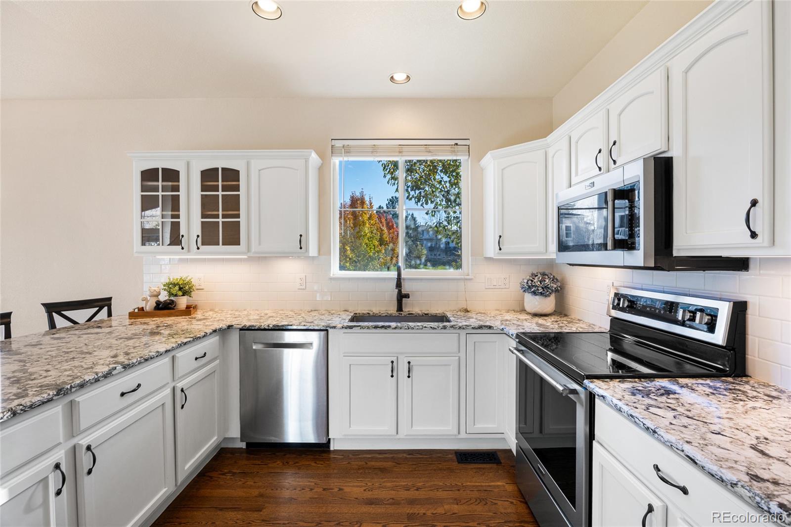 10655 Cherrybrook Circle Highlands Ranch, CO 80126 - Photo 9 of 42 a kitchen with a sink stove top oven and refrigerator