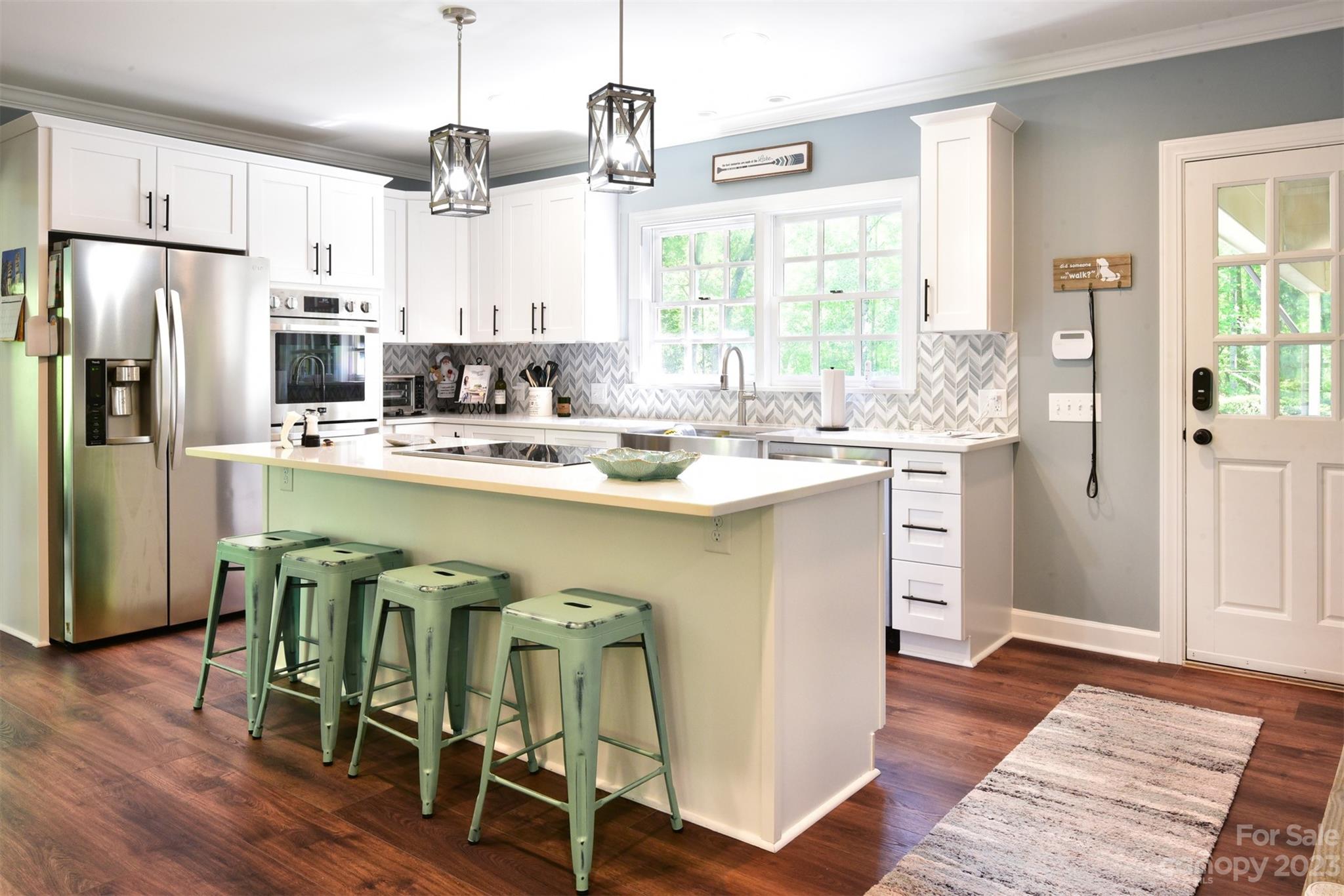 316 Biscoe Road Troy, NC 27371 - Photo 10 of 39 a kitchen with stainless steel appliances granite countertop a hardwood floor and window