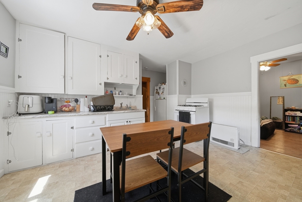 436 Franklin Road Fitchburg, MA 01420 - Photo 22 of 41 a kitchen with stainless steel appliances a table chairs refrigerator and cabinets