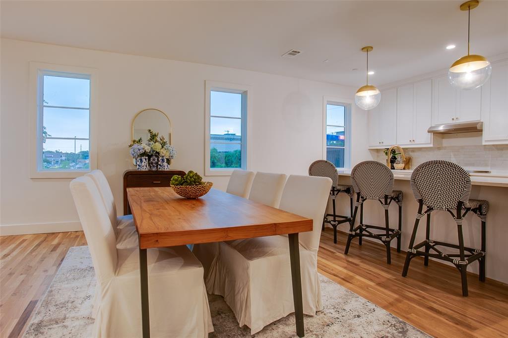 7207 Gaston Avenue, Unit 906 Dallas, TX 75214 - Photo 12 of 34 a view of a dining room with furniture and a chandelier