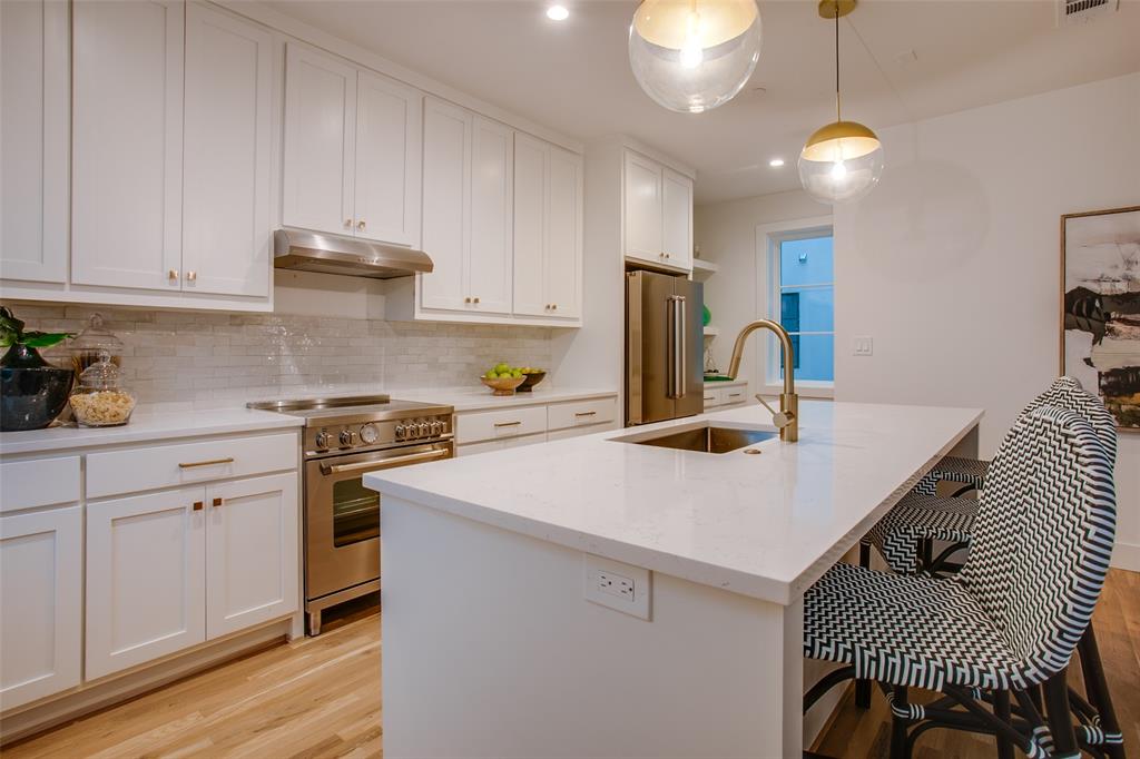 7207 Gaston Avenue, Unit 906 Dallas, TX 75214 - Photo 17 of 34 a kitchen with a sink a stove and cabinets