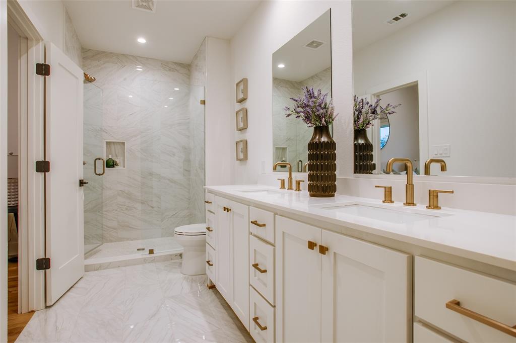 7207 Gaston Avenue, Unit 906 Dallas, TX 75214 - Photo 33 of 34 a bathroom with a double vanity sink mirror double shower and a toilet