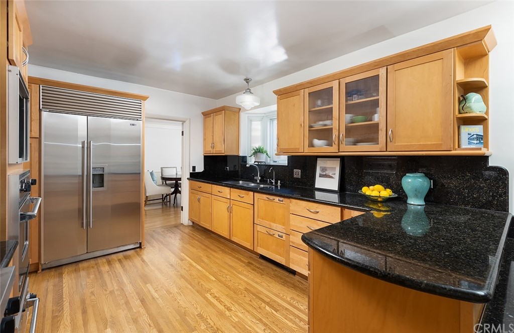 910 East Maple Avenue Orange, CA 92866 - Photo 11 of 38 a kitchen with granite countertop a stove and a refrigerator