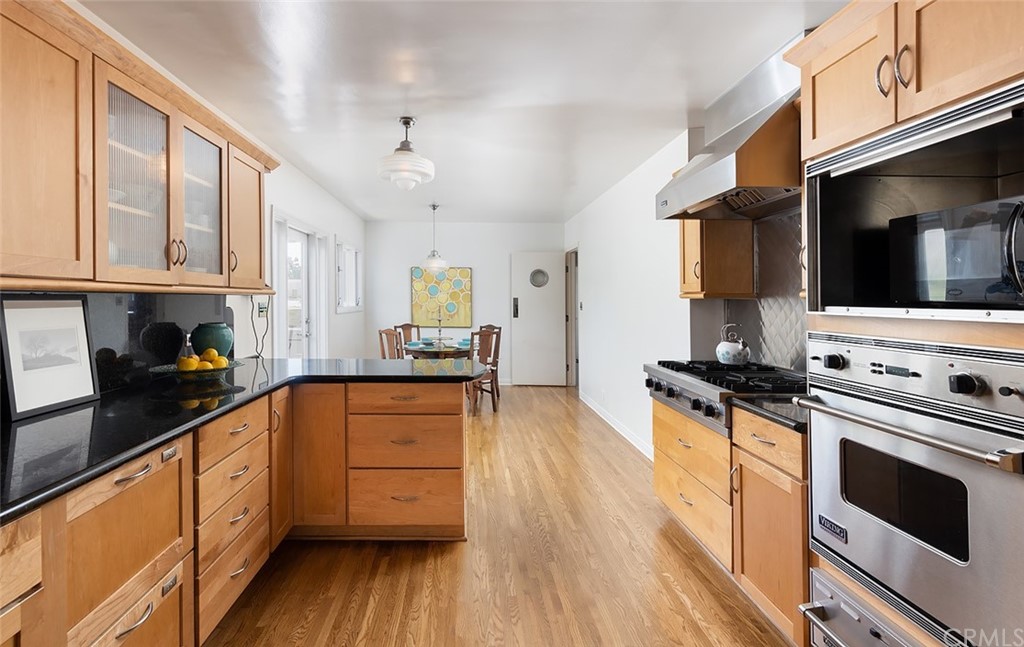 910 East Maple Avenue Orange, CA 92866 - Photo 12 of 38 a kitchen with stainless steel appliances a stove sink microwave and cabinets