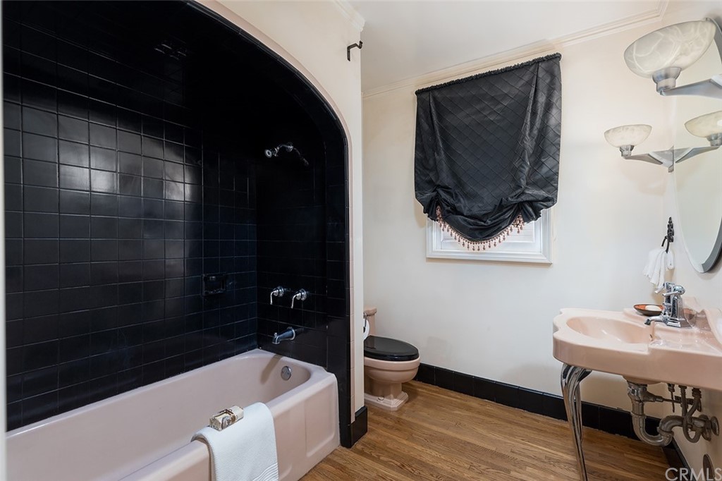 910 East Maple Avenue Orange, CA 92866 - Photo 18 of 38 a bathroom with a sink a toilet a mirror and bathtub