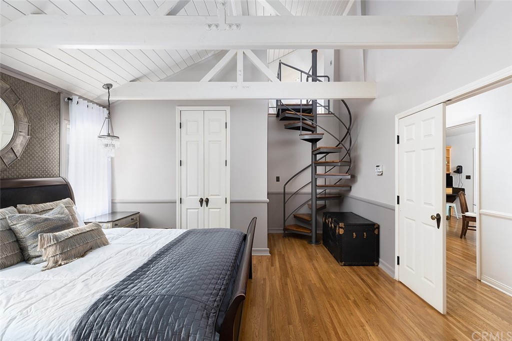 910 East Maple Avenue Orange, CA 92866 - Photo 21 of 38 a bedroom with a bed and wooden floor