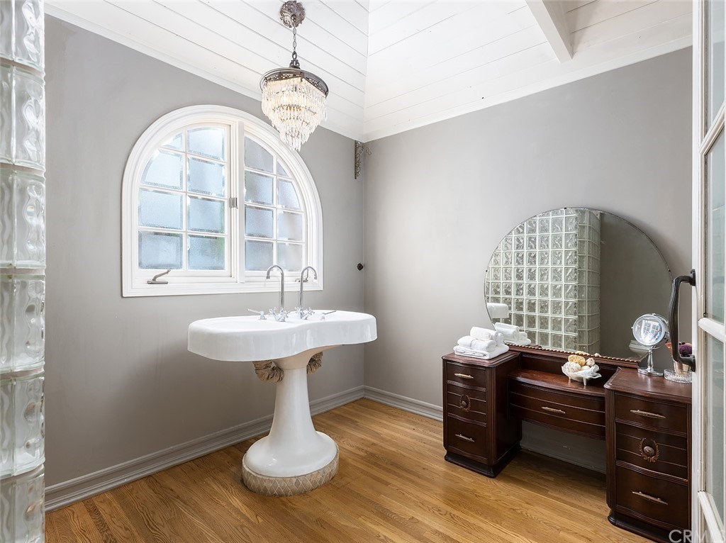 910 East Maple Avenue Orange, CA 92866 - Photo 22 of 38 a bathroom with a sink a mirror and a window