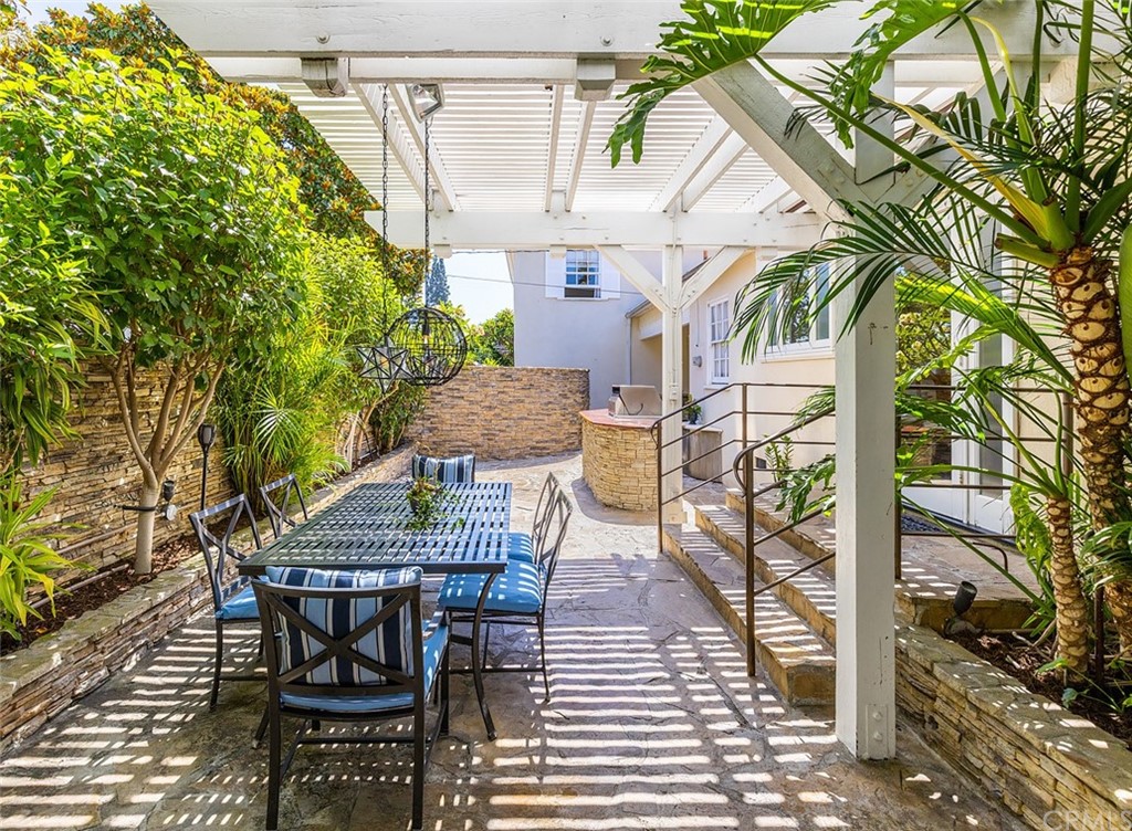 910 East Maple Avenue Orange, CA 92866 - Photo 28 of 38 a view of a patio with table and chairs and potted plants