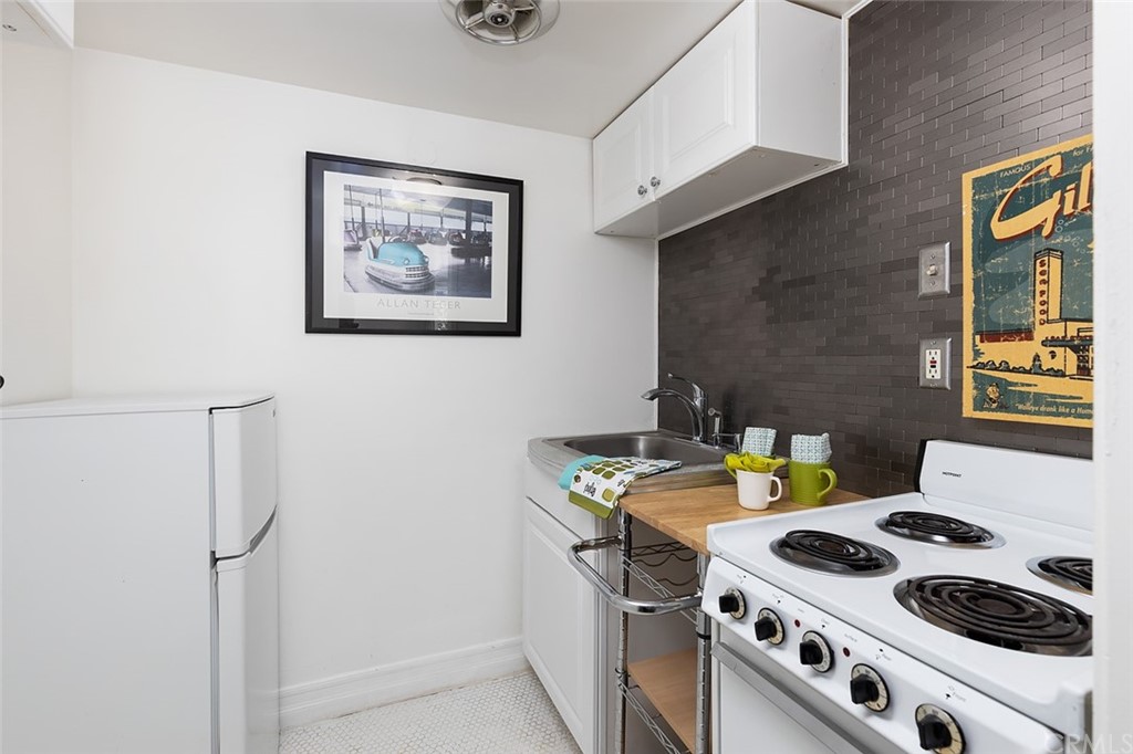 910 East Maple Avenue Orange, CA 92866 - Photo 33 of 38 a white stove top oven sitting inside of a house