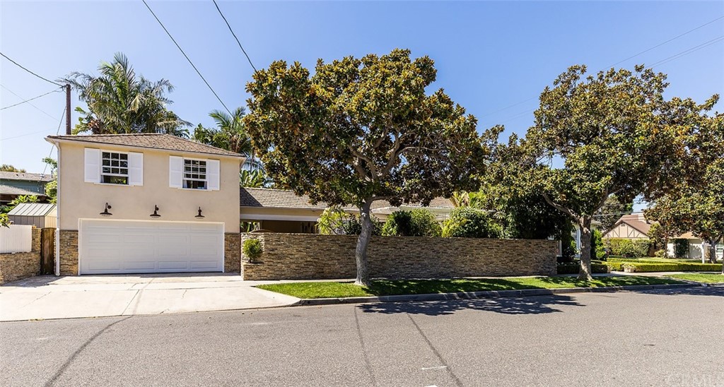 910 East Maple Avenue Orange, CA 92866 - Photo 4 of 38 a front view of a house with a yard and garage