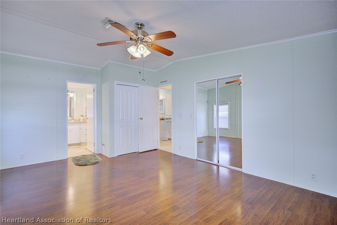 2702 Rodney Street Sebring, FL 33872 - Photo 17 of 33 a view of an empty room with wooden floor and a window