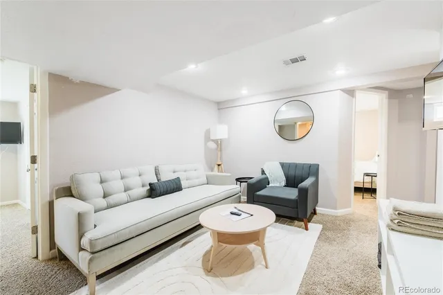 a living room with furniture and wooden floor