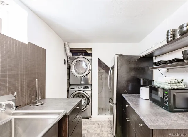 a kitchen with sink cabinets and stainless steel appliances