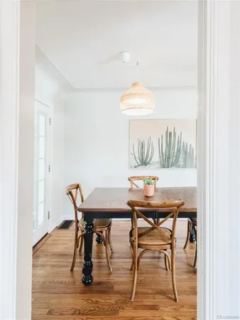 a view of a dining room with furniture and wooden floor