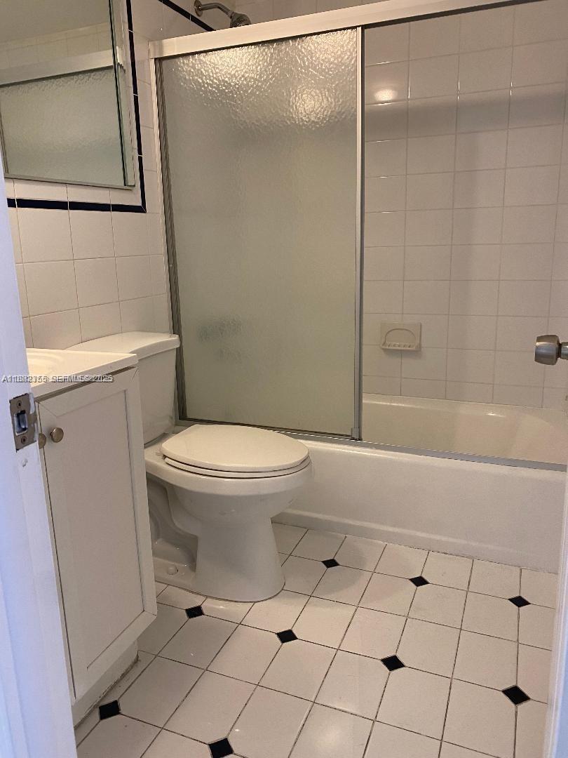 7725 Southwest 86th Street, Unit A1421 Miami, FL 33143 - Photo 5 of 6 a bathroom with a toilet and a shower