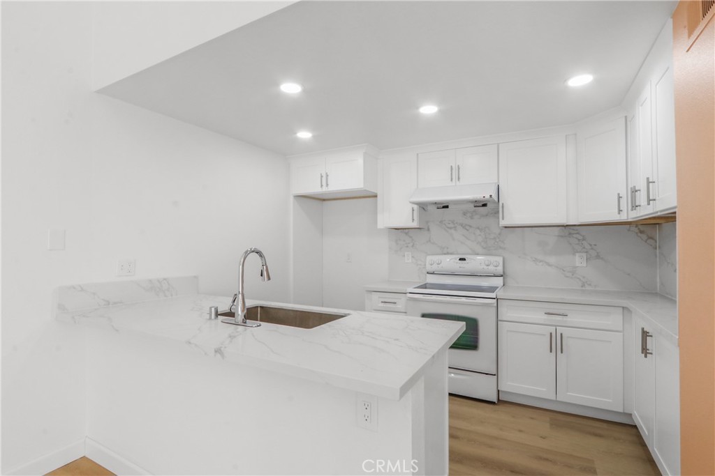 22 Fabriano Irvine, CA 92620 - Photo 11 of 20 a kitchen with kitchen island a sink stainless steel appliances and cabinets
