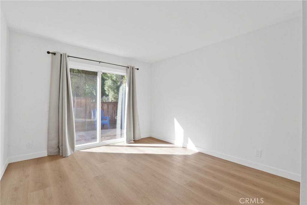 22 Fabriano Irvine, CA 92620 - Photo 16 of 20 a view of an empty room with wooden floor and a window