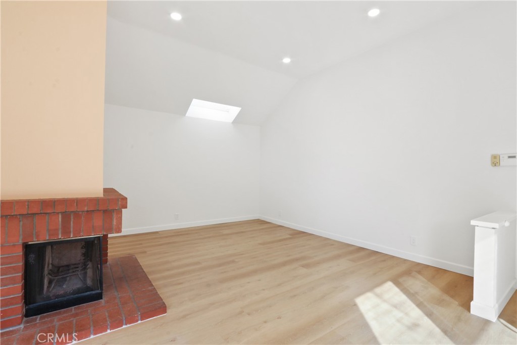 22 Fabriano Irvine, CA 92620 - Photo 5 of 20 a view of an empty room with wooden floor and a fireplace