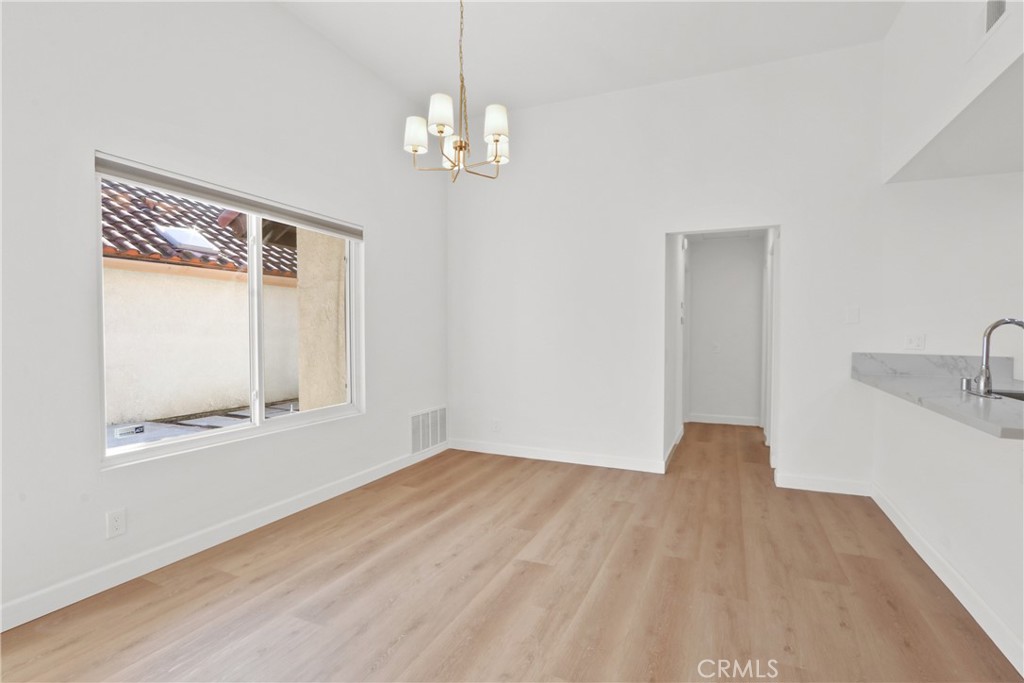 22 Fabriano Irvine, CA 92620 - Photo 8 of 20 a view of an empty room with wooden floor and a window