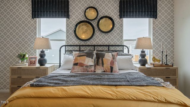 a bedroom with a bed and dresser with mirror