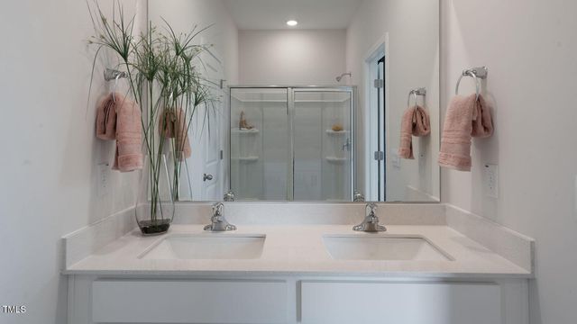 a bathroom with a glass shower door