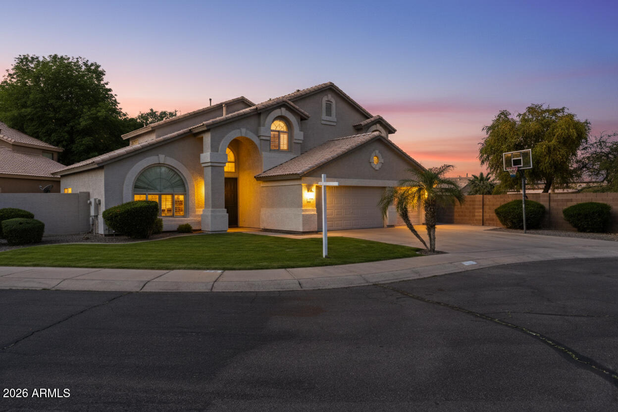 418 South Burk Street Gilbert, AZ 85296 - Photo 1 of 90 a front view of a house with a yard and garage