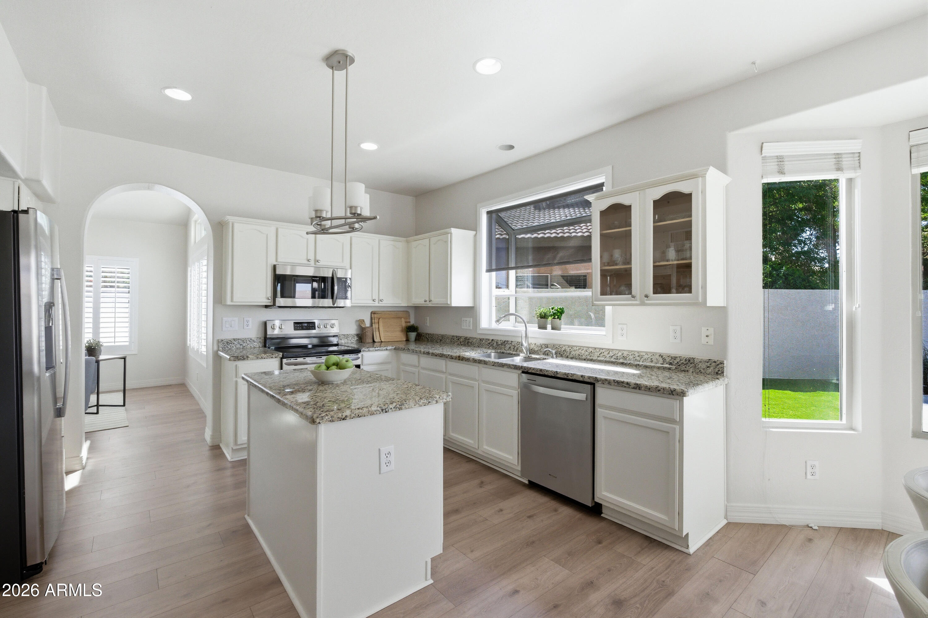 418 South Burk Street Gilbert, AZ 85296 - Photo 21 of 90 a kitchen with stainless steel appliances granite countertop a stove and cabinets