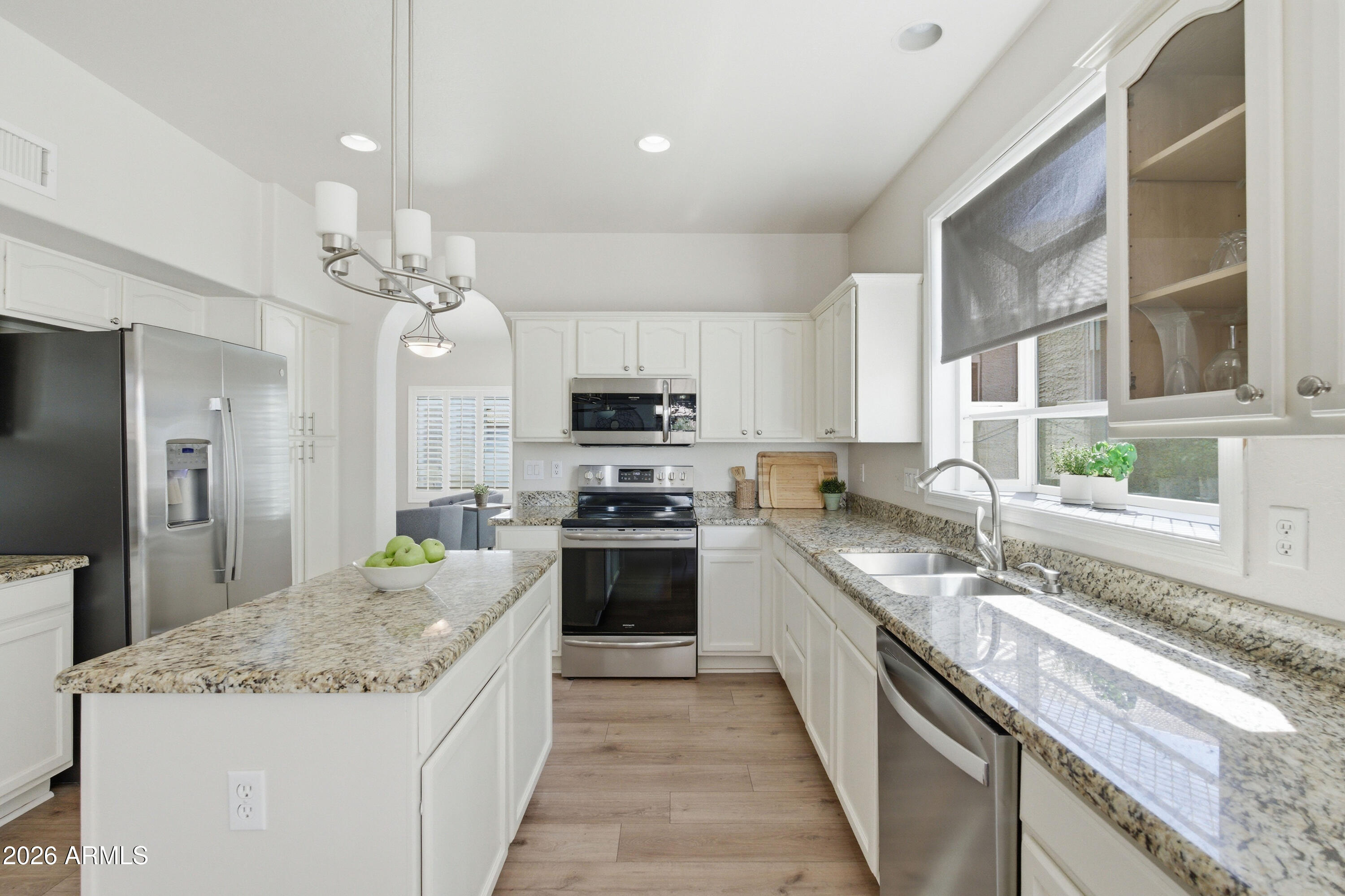 418 South Burk Street Gilbert, AZ 85296 - Photo 23 of 90 a large kitchen with stainless steel appliances granite countertop a stove oven and a sink