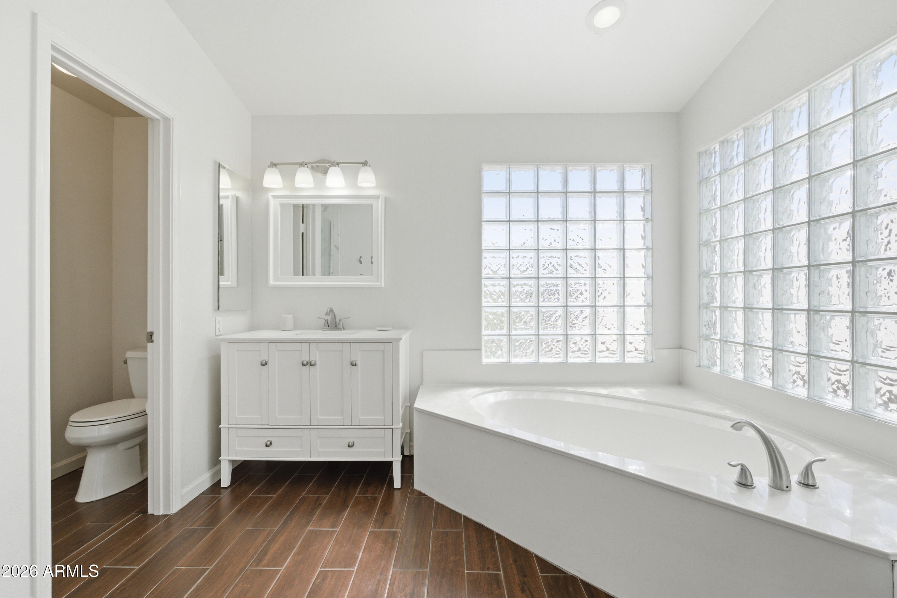 418 South Burk Street Gilbert, AZ 85296 - Photo 41 of 90 a spacious bathroom with a tub sink toilet and a window