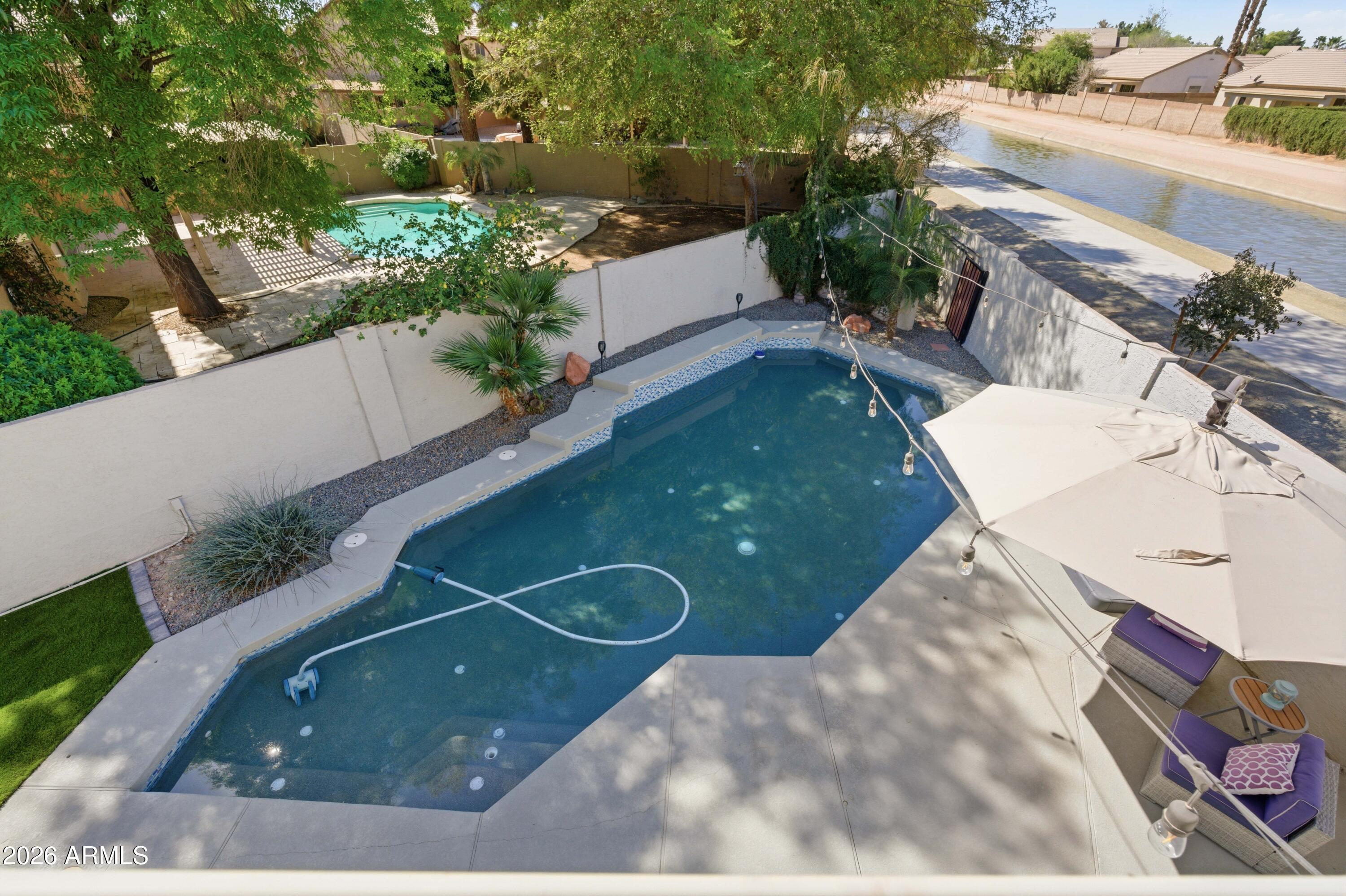 418 South Burk Street Gilbert, AZ 85296 - Photo 48 of 90 a view of a swimming pool with a patio