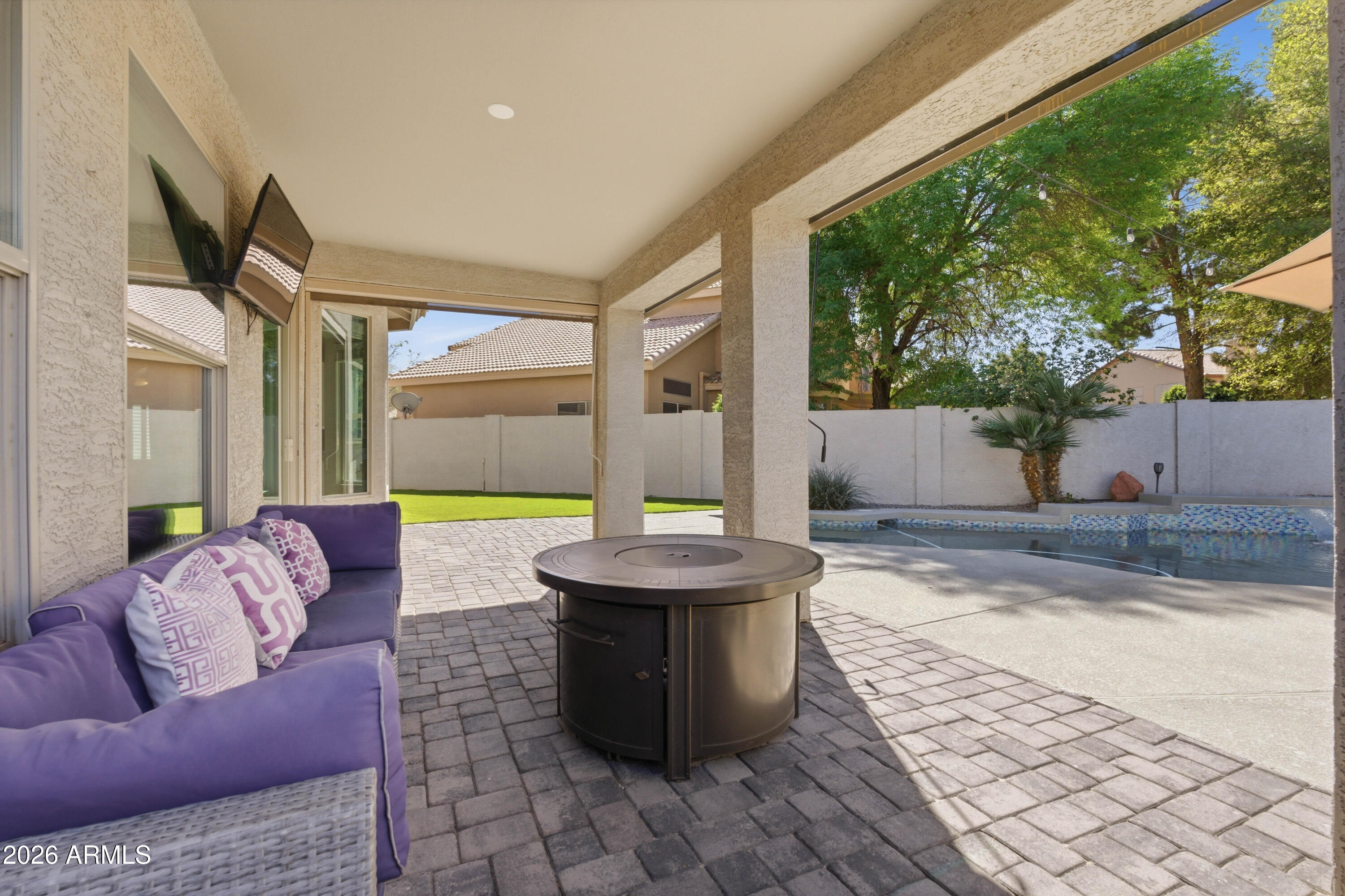 418 South Burk Street Gilbert, AZ 85296 - Photo 58 of 90 a living room with patio furniture and a fireplace