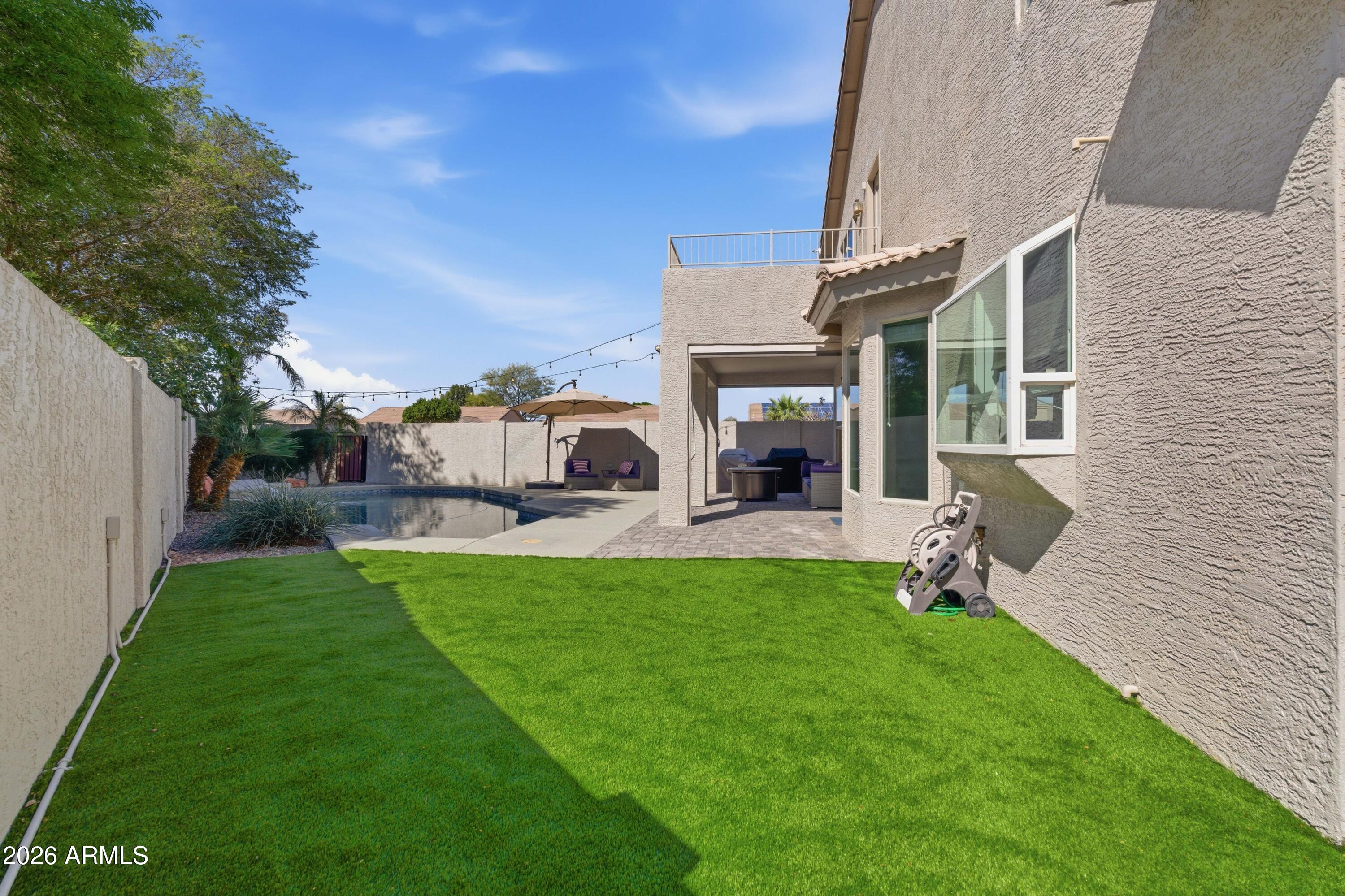 418 South Burk Street Gilbert, AZ 85296 - Photo 67 of 90 a view of a house with backyard sitting area and garden